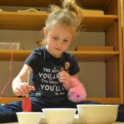 testimonial_1 Child scooping materials into three bowls