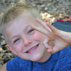 testimonials_2 Smiling kid giving the OK sign