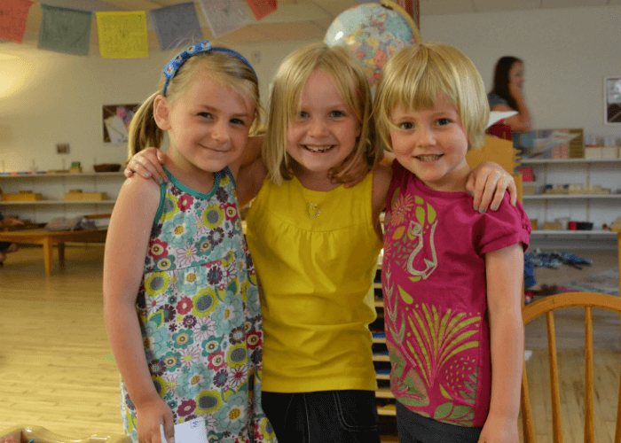 Three young girls standing together